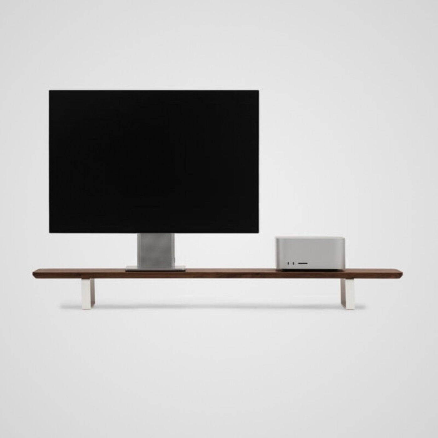 Modern walnut wood desktop shelf with monitor and silver computer on minimalist white background