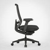 Black ergonomic office chair with adjustable armrests and mesh back, side view