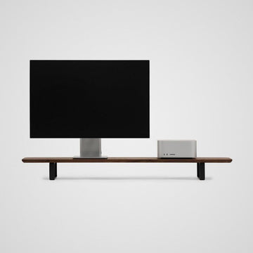 Pelicanwork walnut wood monitor stand with black metal legs, supporting a monitor and desktop computer