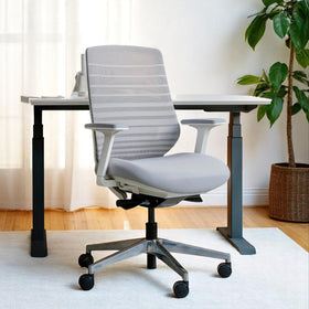 Pelicanwork grey ergonomic office chair with mesh back at a modern desk