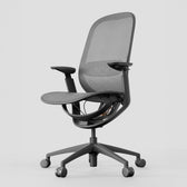 Black ergonomic office chair with mesh back and seat, adjustable arms, and wheels