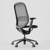 Black ergonomic office chair with mesh back, adjustable armrests and lumbar support