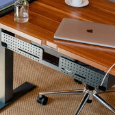 Cable organizer black under desk for office workspace with laptop and ergonomic chair