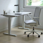 Pelicanwork Model 92 X white ergonomic office chair at modern standing desk in minimalist workspace