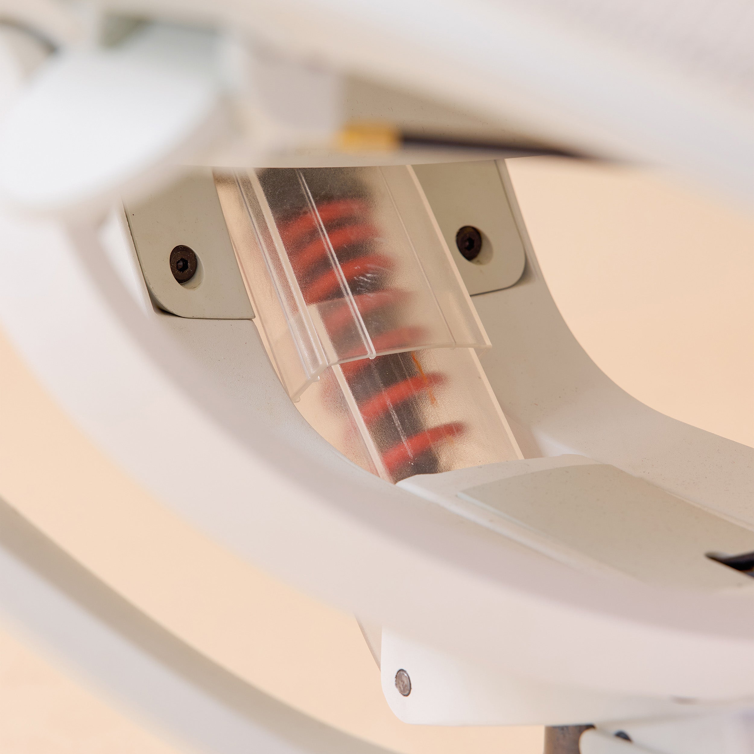 Closeup of white Pelicanwork ergonomic office chair spring lumbar support mechanism